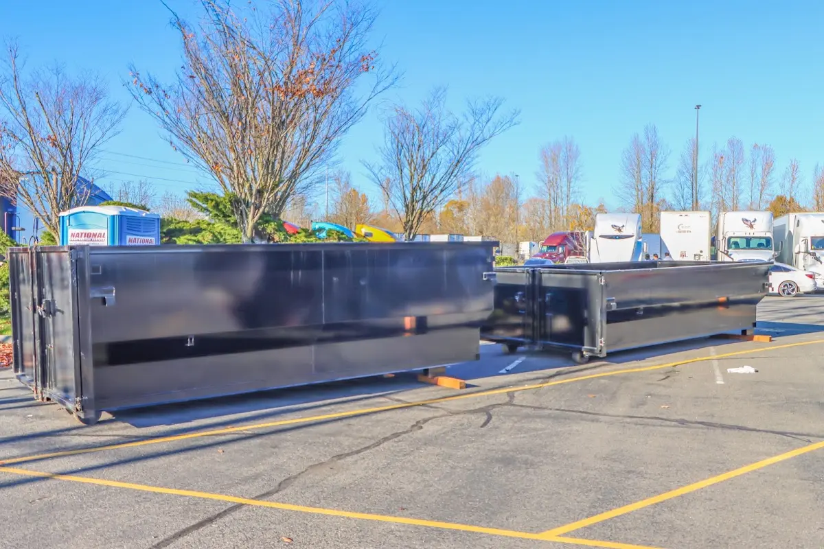 Professional dumpster rental service with roll-off container on residential driveway in Lenexa